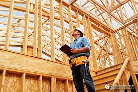 man looking at house under construction